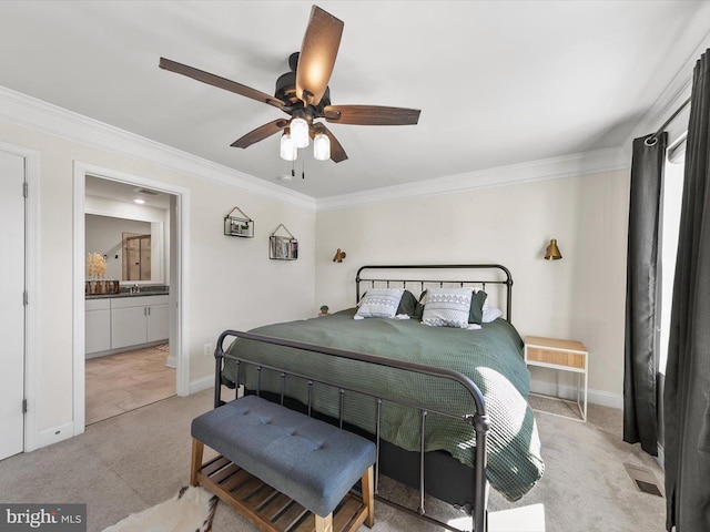 bedroom featuring crown molding, ceiling fan, ensuite bathroom, and sink