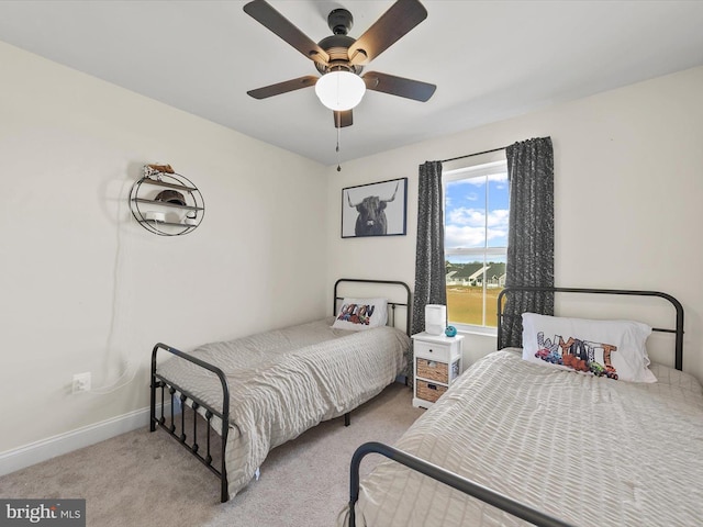 bedroom featuring ceiling fan and light colored carpet