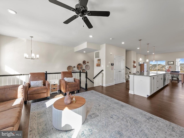 living room with dark wood-type flooring and a notable chandelier