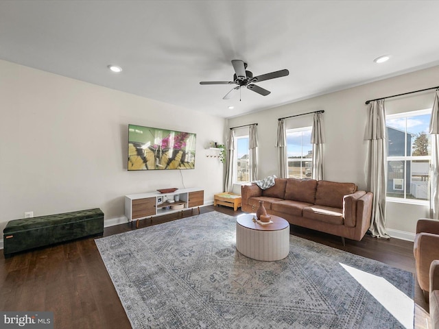 living room with dark hardwood / wood-style floors and ceiling fan