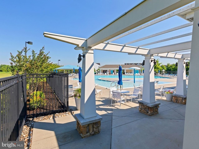 view of patio featuring a community pool and a pergola