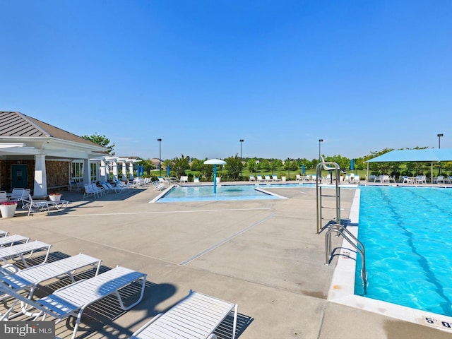 view of pool featuring pool water feature and a patio area