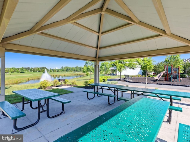 view of swimming pool featuring a water view, a playground, and a gazebo