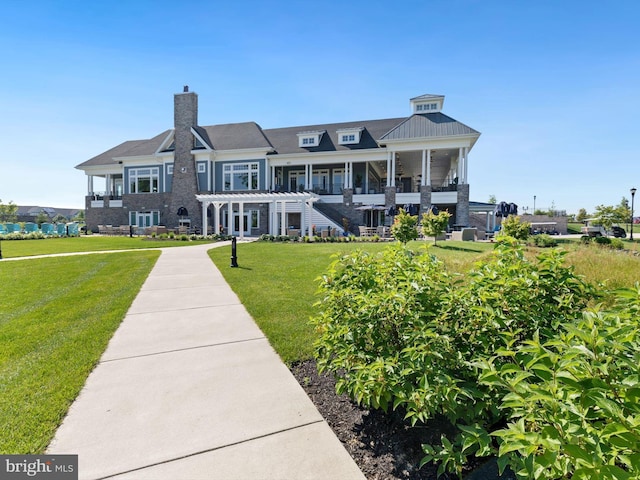 rear view of house with a yard and a pergola