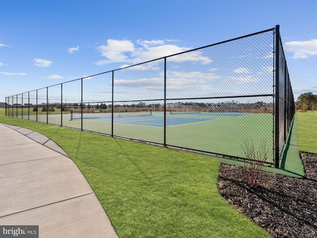 view of sport court featuring a lawn