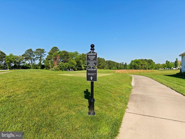 view of home's community with a yard