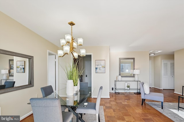 dining room with parquet flooring and a notable chandelier