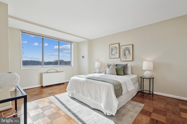 bedroom featuring parquet flooring and radiator