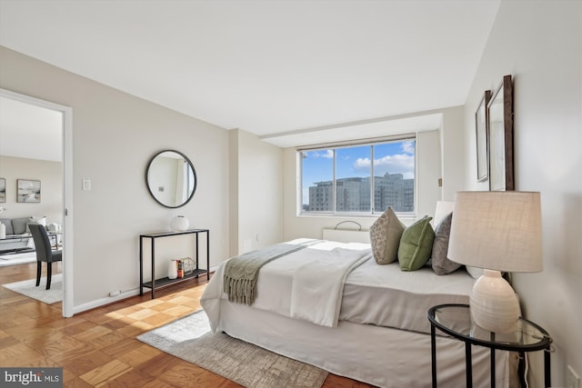 bedroom with light parquet flooring