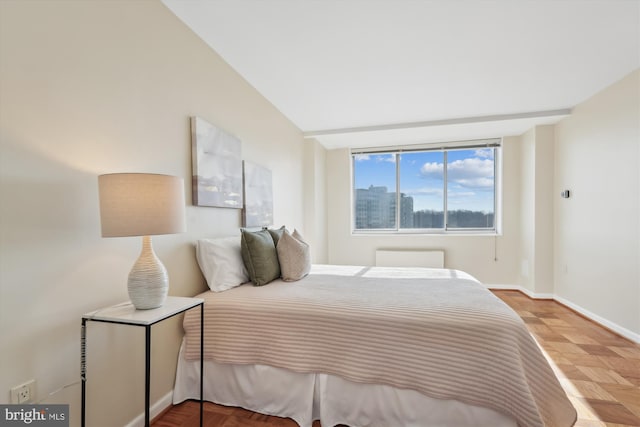 bedroom featuring parquet flooring