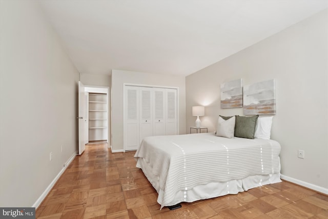 bedroom with parquet floors and a closet