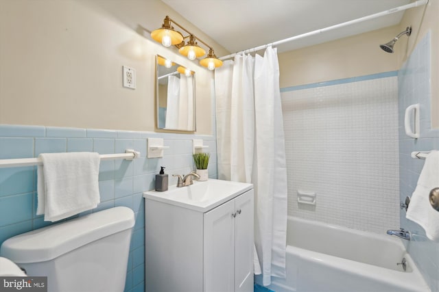 full bathroom featuring vanity, tile walls, shower / tub combo, and toilet