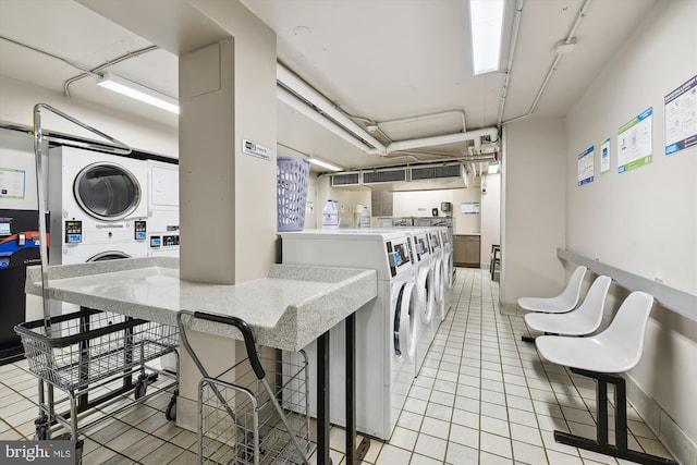 laundry area with separate washer and dryer, stacked washer and dryer, and light tile patterned flooring