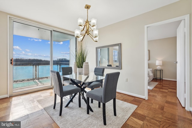 dining room with parquet floors and a notable chandelier