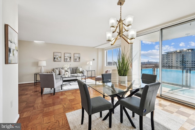 dining room with parquet floors and a notable chandelier