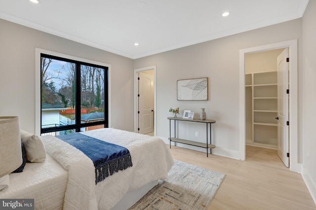 bedroom with light wood-style floors, recessed lighting, ornamental molding, and baseboards