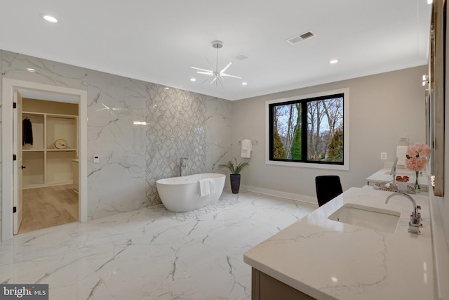 bathroom with a sink, visible vents, marble finish floor, a soaking tub, and double vanity