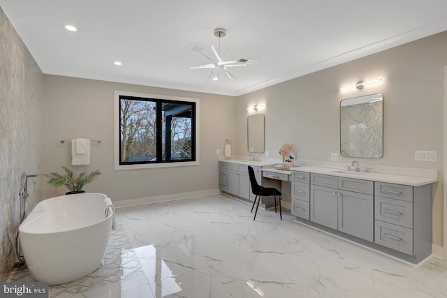 full bathroom featuring double vanity, baseboards, marble finish floor, a freestanding bath, and a sink