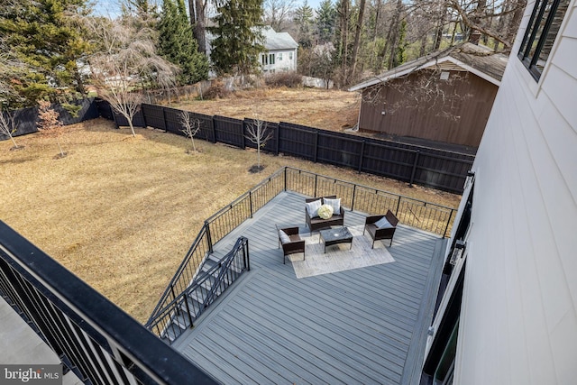 wooden deck featuring a fenced backyard and an outdoor living space