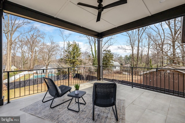 view of patio featuring a balcony and a ceiling fan