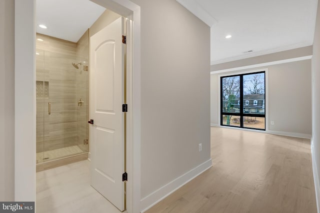 hall featuring light wood-type flooring, baseboards, and recessed lighting