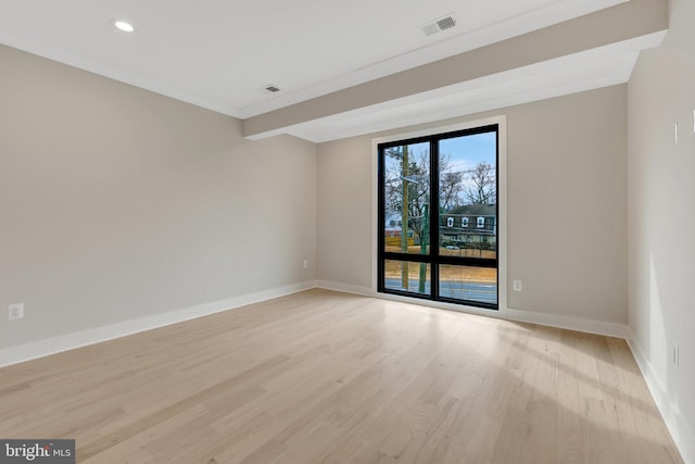 empty room featuring recessed lighting, visible vents, light wood-style flooring, and baseboards