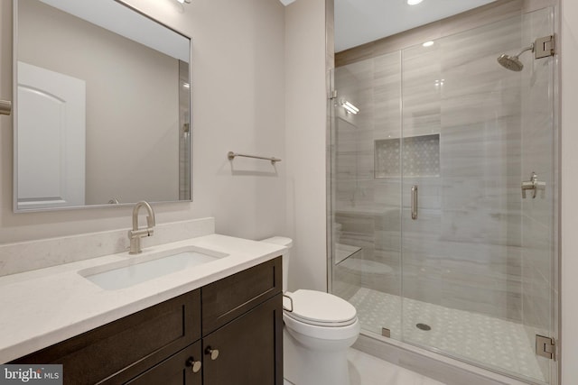 full bathroom with a stall shower, vanity, and toilet