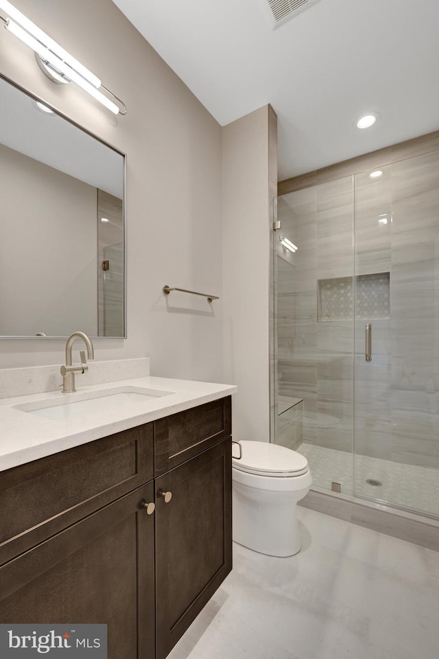 full bathroom featuring toilet, a stall shower, tile patterned floors, and vanity