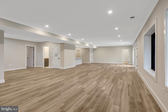 unfurnished living room featuring baseboards, light wood-style floors, and recessed lighting