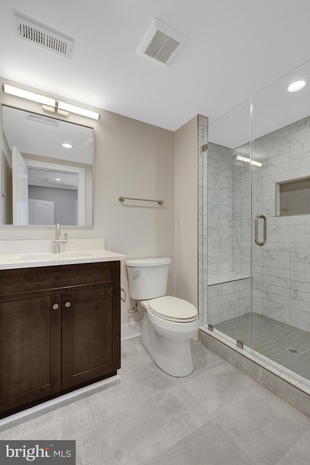 full bathroom featuring toilet, a shower stall, visible vents, and vanity