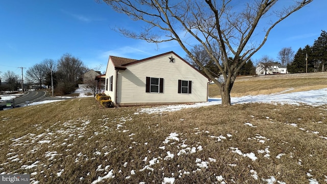 snow covered property with a lawn