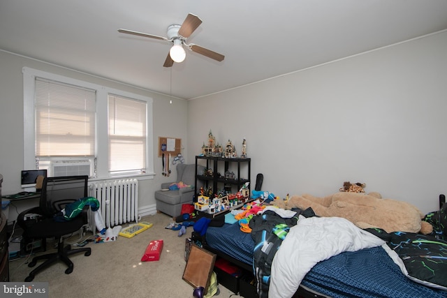 carpeted bedroom with radiator heating unit and ceiling fan