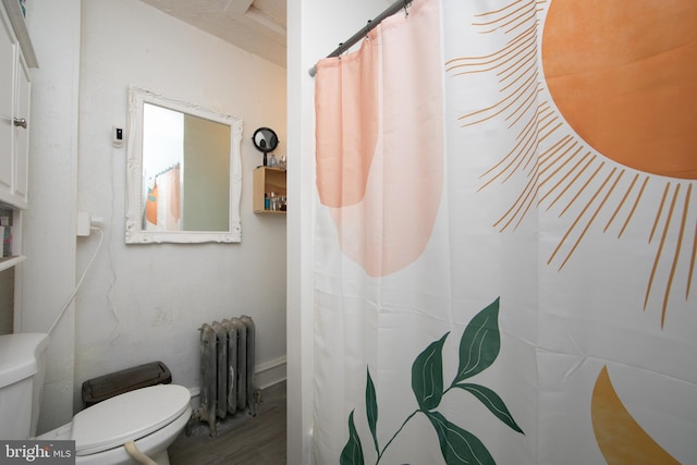 bathroom featuring radiator, wood-type flooring, and toilet