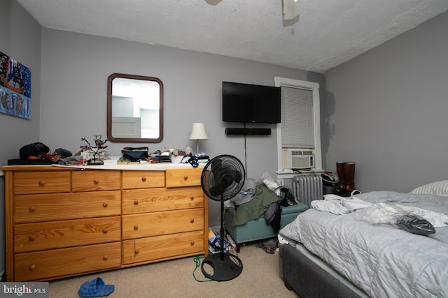 bedroom with cooling unit, ceiling fan, radiator, and carpet