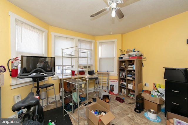 interior space with ceiling fan