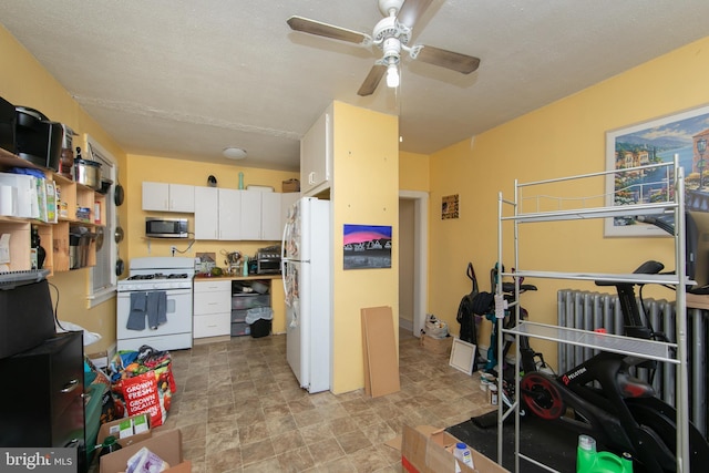 kitchen featuring white cabinetry, white appliances, and ceiling fan