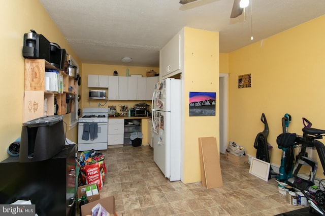 kitchen featuring ceiling fan, white appliances, and white cabinets