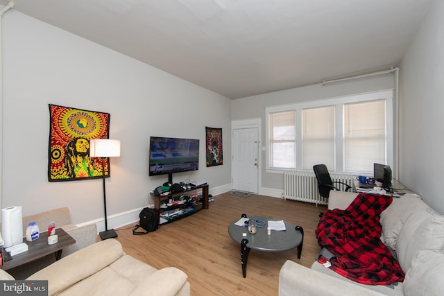 living room with radiator heating unit and hardwood / wood-style floors