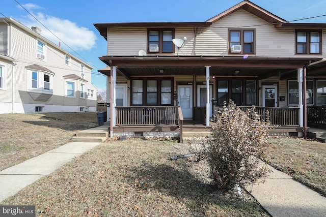 view of front of property with cooling unit and covered porch