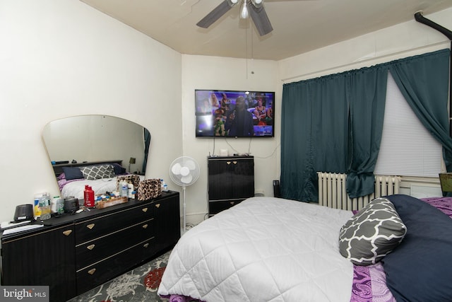 bedroom featuring ceiling fan and radiator