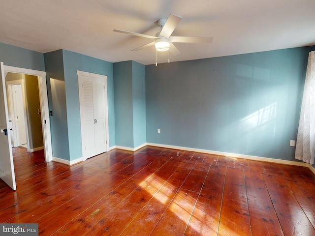 unfurnished bedroom with hardwood / wood-style flooring, ceiling fan, and baseboards