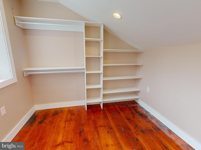 walk in closet featuring lofted ceiling and hardwood / wood-style flooring