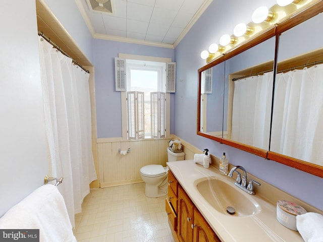 full bath featuring a wainscoted wall, vanity, toilet, and crown molding