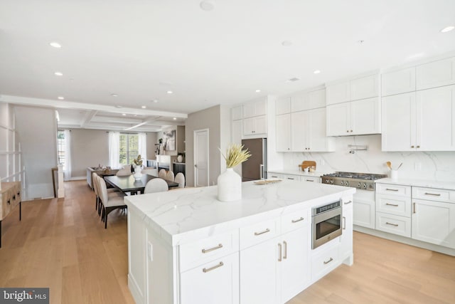 kitchen featuring white cabinetry, stainless steel appliances, and a center island