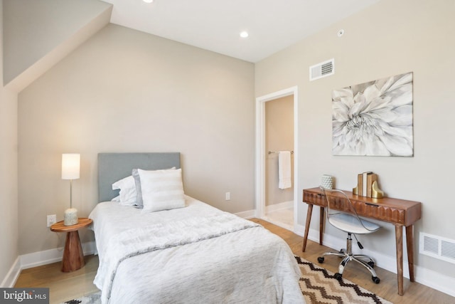 bedroom featuring vaulted ceiling and light hardwood / wood-style floors