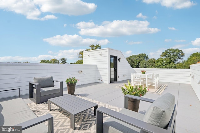 view of patio / terrace featuring an outdoor hangout area and a storage shed