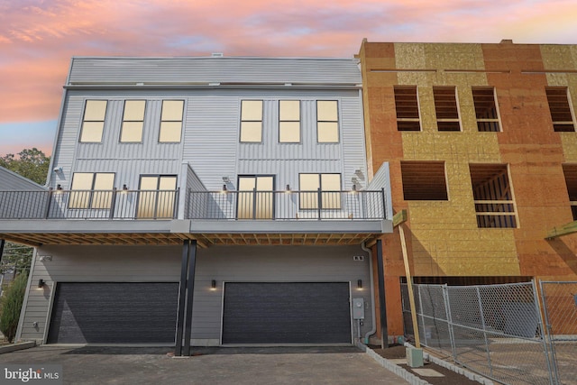 exterior space with a garage and a balcony