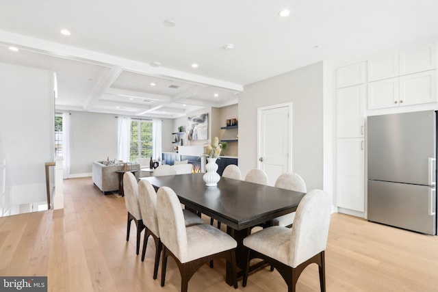 dining area with coffered ceiling, beamed ceiling, and light wood-type flooring