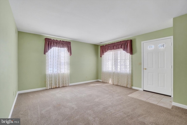 foyer with plenty of natural light and light carpet