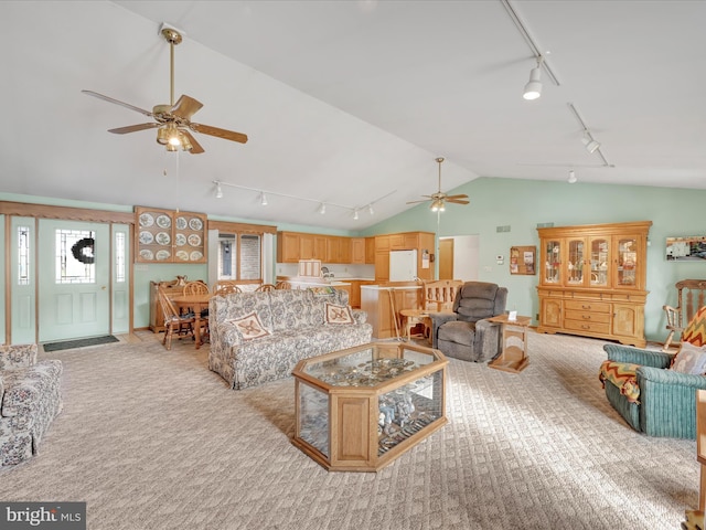 living room with ceiling fan, lofted ceiling, and light carpet